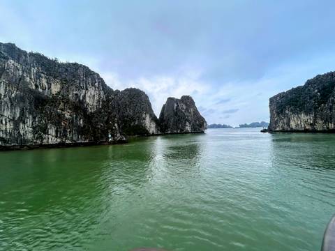 Ha Long Bay with tall limestone formations and calm waters.