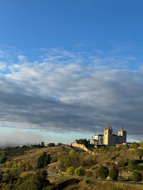 Church spire visible against a cloudy sky.