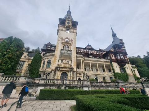       Ornate palace with lush greenery in cloudy weather.
  