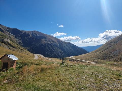       Mountain road winding through rolling hills.
  
