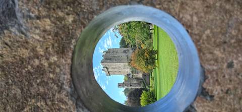 A castle seen through a circular stone frame.