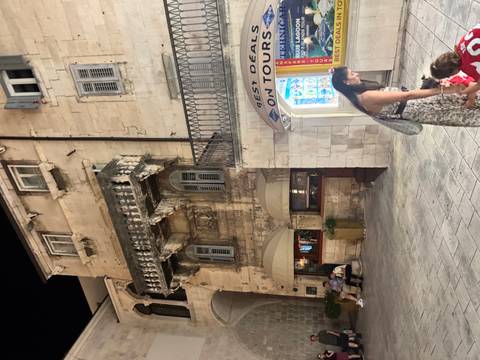 Nighttime street scene with historic stone buildings.