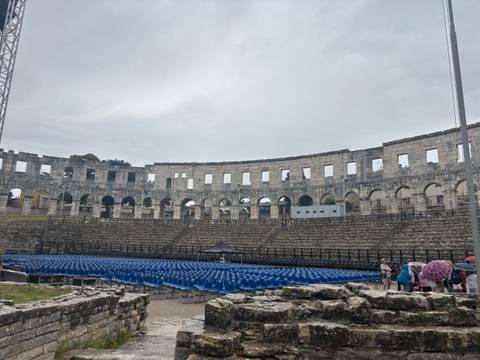 Ancient Roman arena with a setup for an event.