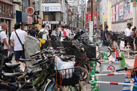 Crowded city street filled with bicycles and pedestrians.