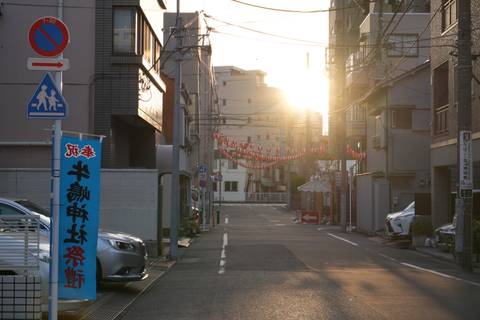 Quiet city street with evening sun casting long shadows.
