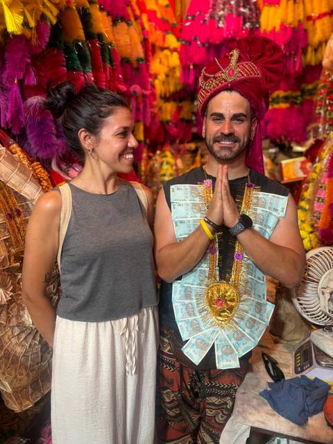       People wearing traditional attire with currency notes.
  