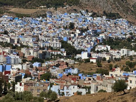       Colorful cityscape with blue-painted buildings.
  