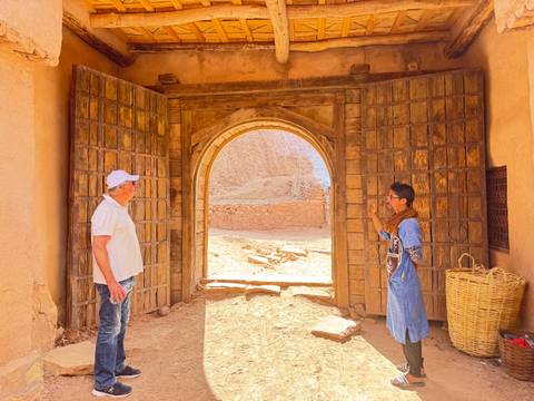 Two men communicating at a historic gate.