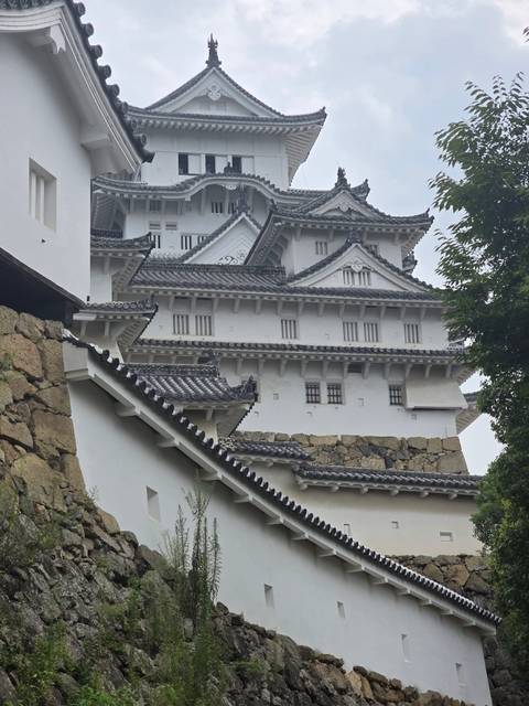 Traditional Japanese castle architecture with stone base.