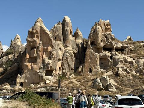 Bizarre rock formations with openings and dwellings carved into them.