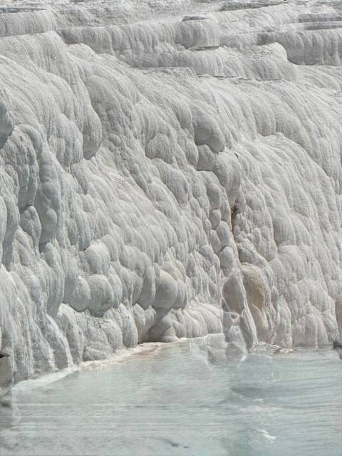 Detailed view of natural rock formations with a textured, layered appearance.