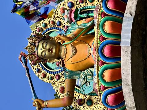       Vibrant statue of a deity with artistic detailing.
  