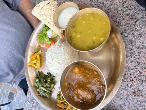 A traditional Nepali meal served on a platter.
