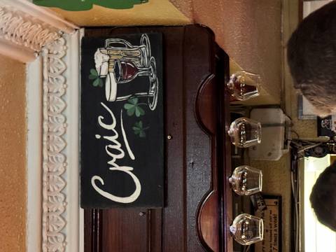 Sign with 'Craic' and drink illustrations, glasses hanging below.