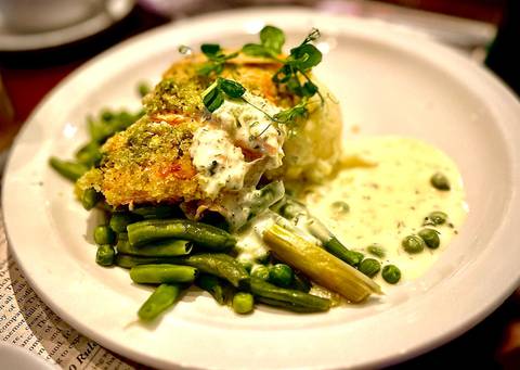       A plate of food with green beans and creamy sauce.
  