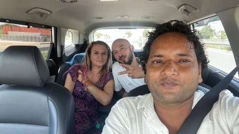 Three people in a car taking a selfie.