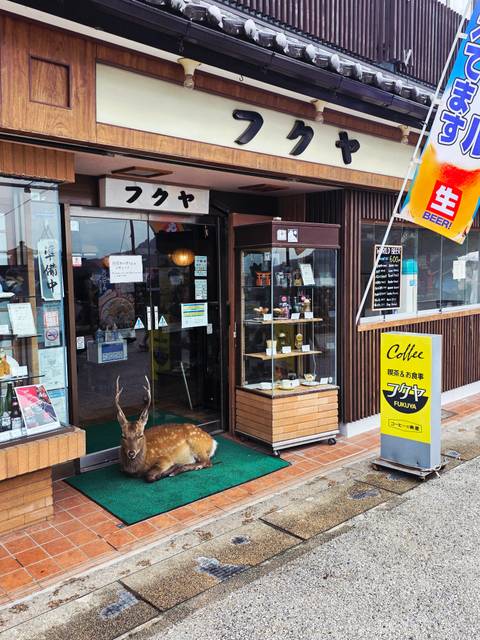 Shopfront named Fukaya with a deer statue in front.