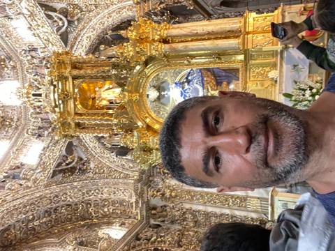       A person taking a selfie in an ornate interior.
  