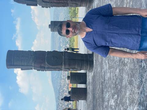 A person with stone columns in the background.