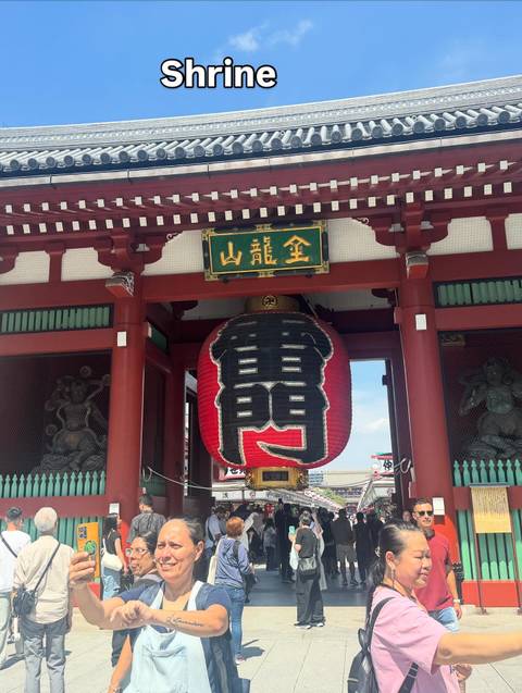       Red temple gate with a large lantern.
  