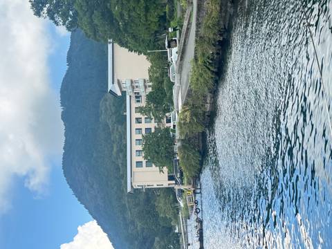      Hotel by a lake with mountains in the background.
  