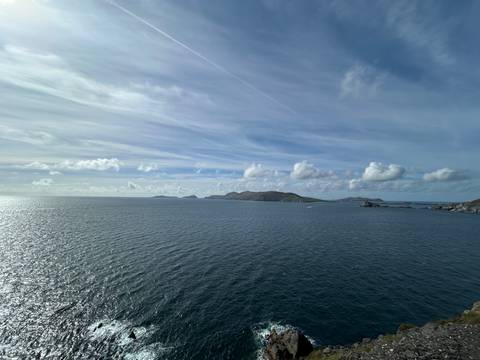 Open sea view with distant islands and a light cloud cover.