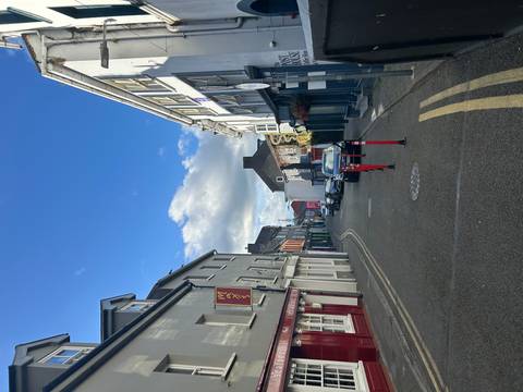 Street view of quaint buildings with blue sky.