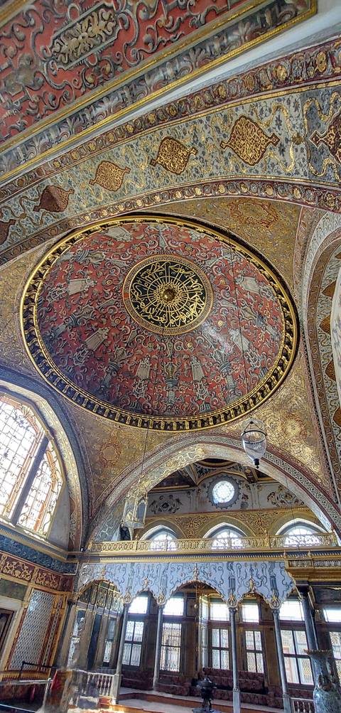 Richly decorated dome interior with intricate patterns.