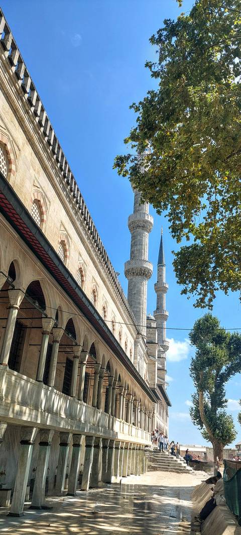 Tall minarets against a clear blue sky.