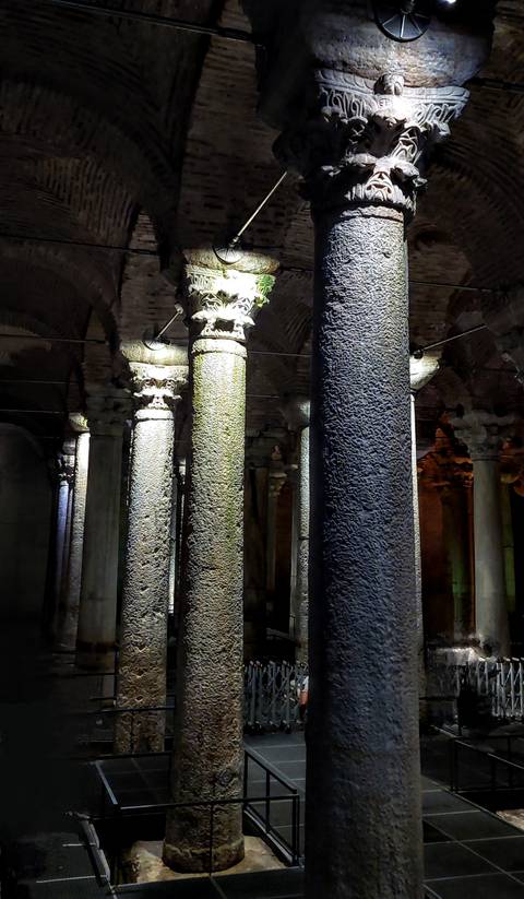 Illuminated columns inside an ancient structure.