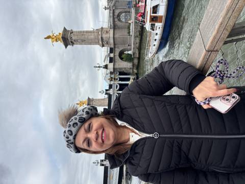 Woman smiling near the Pont Alexandre III bridge in Paris.
