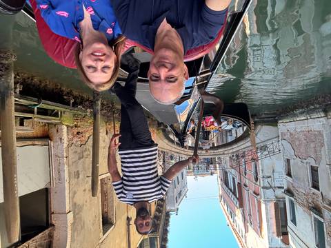 Couple enjoying a gondola ride in Venice's canals.