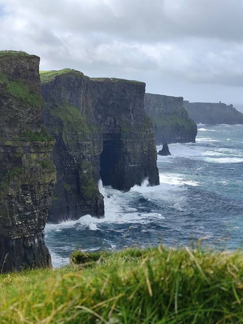 Cliffs of Moher with ocean waves crashing below, Ireland.