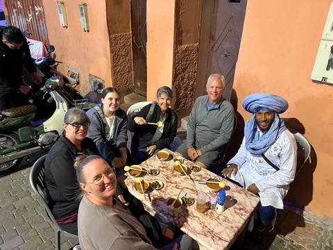 People gathered around a table enjoying food and drinks.