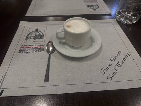 A cup of coffee on a hotel placemat.