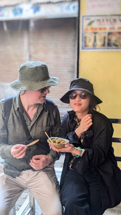       Couple sitting together indoors enjoying a meal.
  