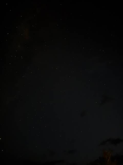       Starry night sky with faint clouds.
  