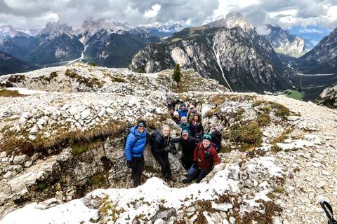 Group of hikers posing with a mountain view.