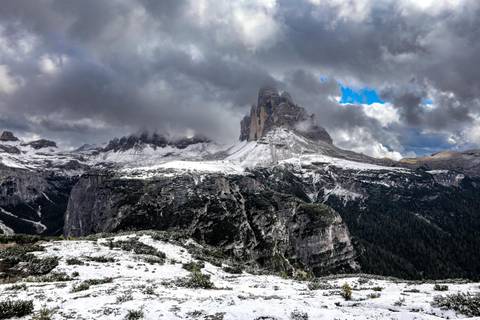 Snowy mountain peaks under a cloudy sky.