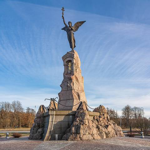 Impressive stone monument under a clear blue sky.