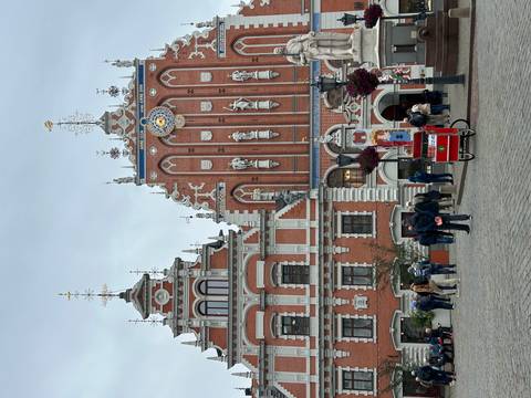       Brightly colored historical buildings with a crowd.
  