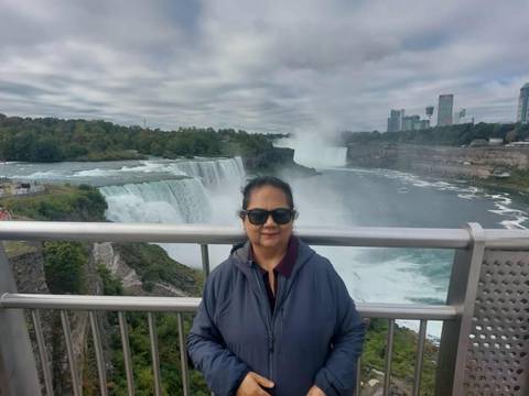       Woman in front of Niagara Falls.
  