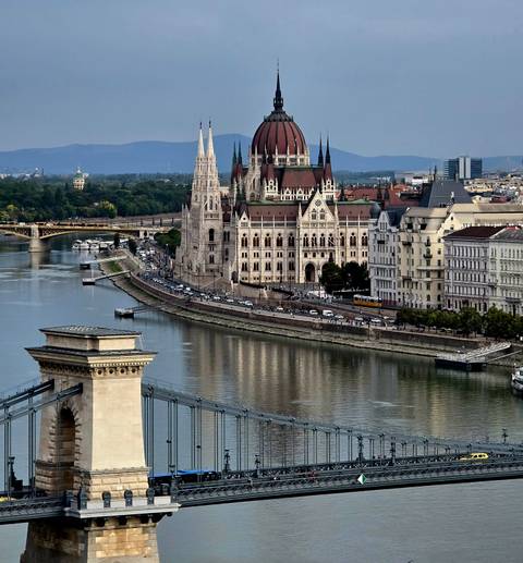       Panoramic city view including a parliament building and river.
  