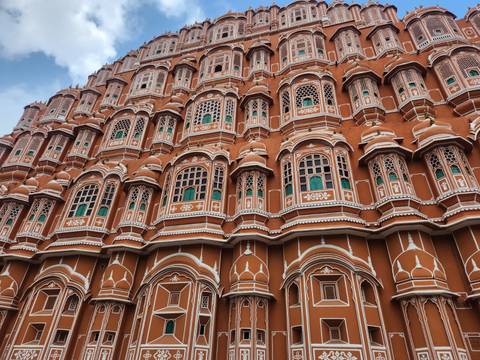 Facade of Hawa Mahal with numerous windows.