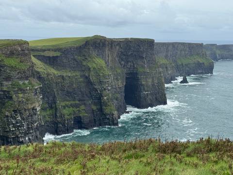 Stunning cliffs meeting the ocean with striking waves.