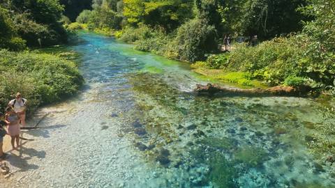 Crystal clear spring with people around