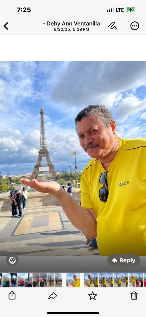 Person holding out hand towards the Eiffel Tower in Paris.