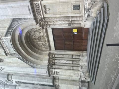       Intricately designed large wooden door of a church entrance.
  