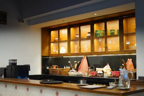       Interior with shelf displaying craft items in a room or restaurant.
  