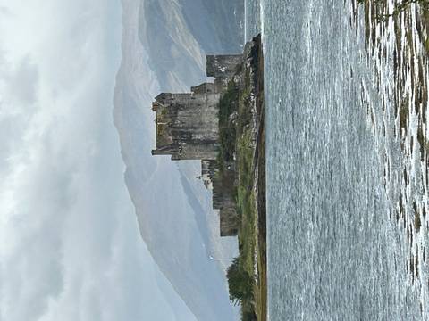 Eilean Donan Castle in Scotland during a cloudy day.